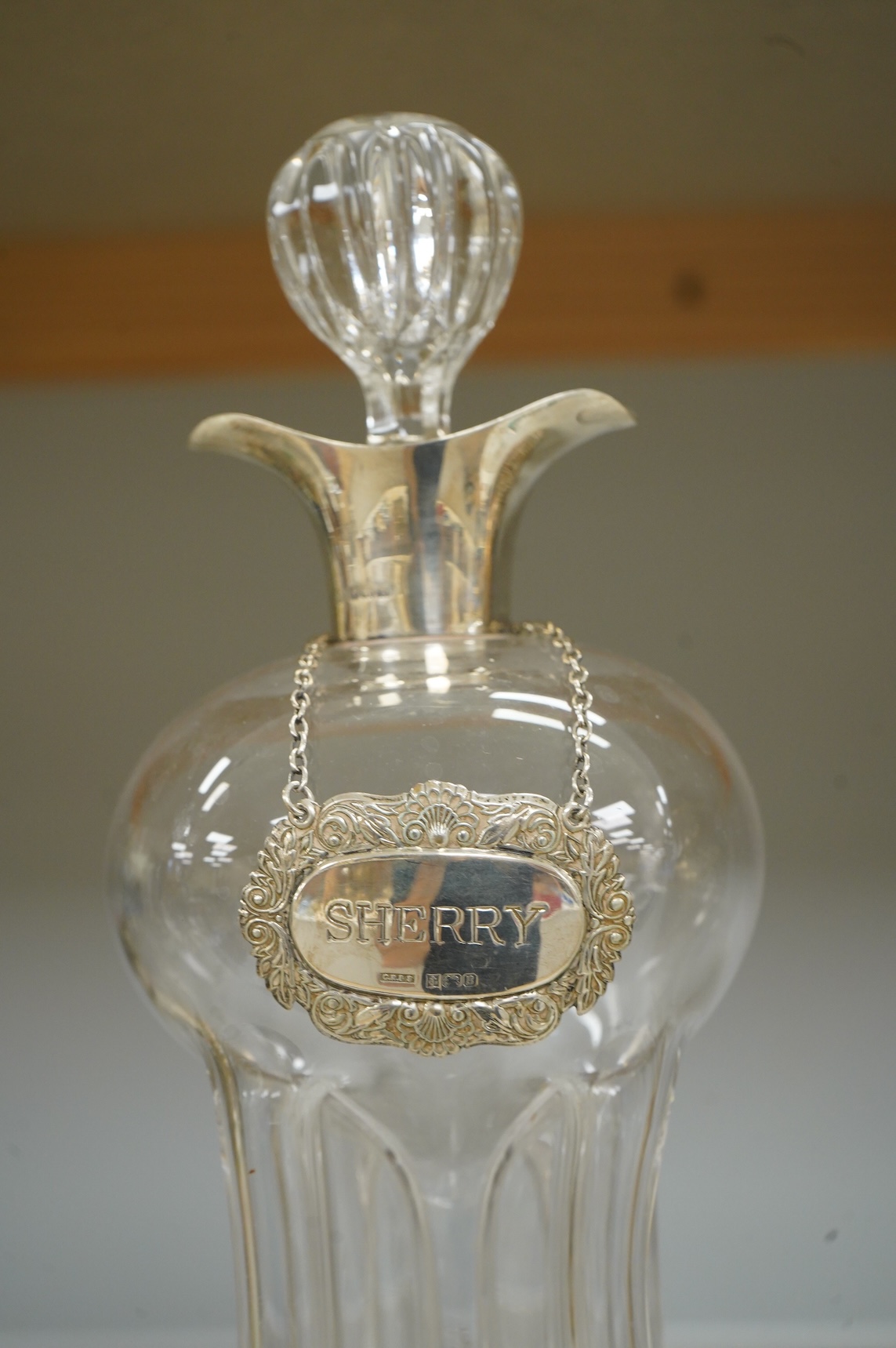 A silver collared glass decanter and ‘sherry’ label, 29cm